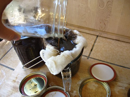 straining cold brew iced coffee